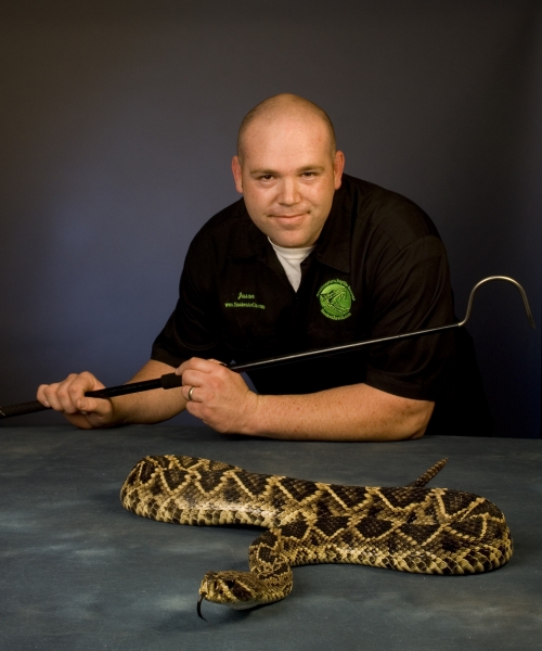 Jason Clark with an eastern diamondback rattlesnake (photo by Warren Bond)